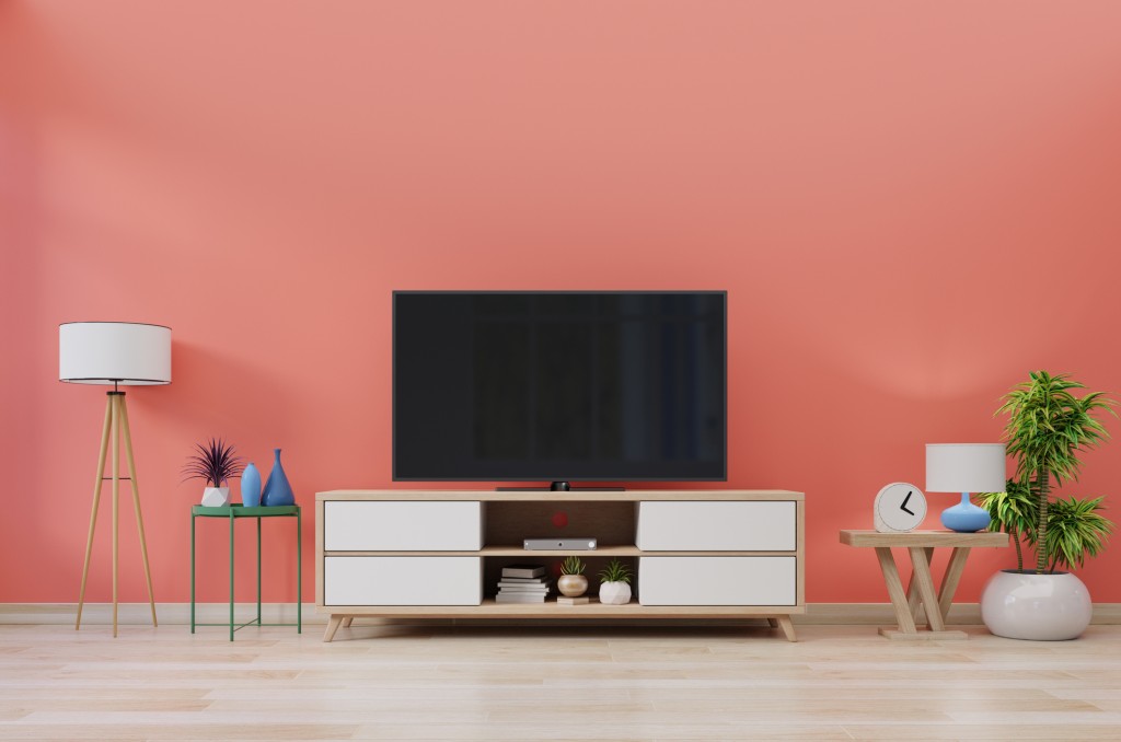 TV in modern room with decoration on living coral color wall background,3d rendering