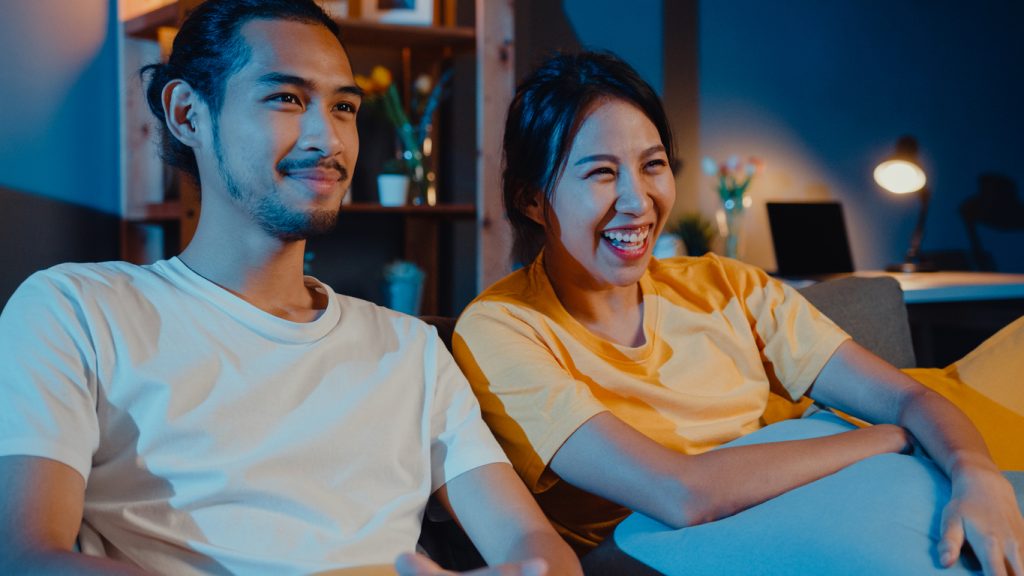 Couple watching personalised content on their smart TV.