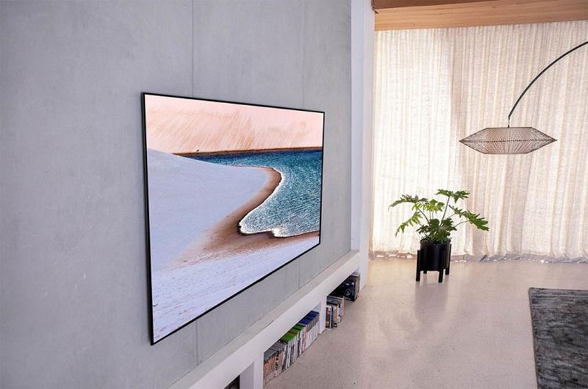 Modern flatscreen television wall mounted in a white contemporary living room